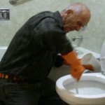 Accent Inns Founder Terry Farmer seen cleaning a hotel room toilet. online reviews