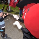 Heartly and a child at the kids coin drive for the Variety Club