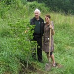 Mandy Farmer CEO of the Victoria BC hotel chain plants BC dogwood in honor of 25 years