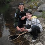 Freshwater Fisheries society staff teaching children how to catch fish