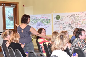 Valerie distributing volunteer gifts to Resource Parents at Training Weekend